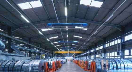 Interior view of a modern industrial hall with steel rollers.