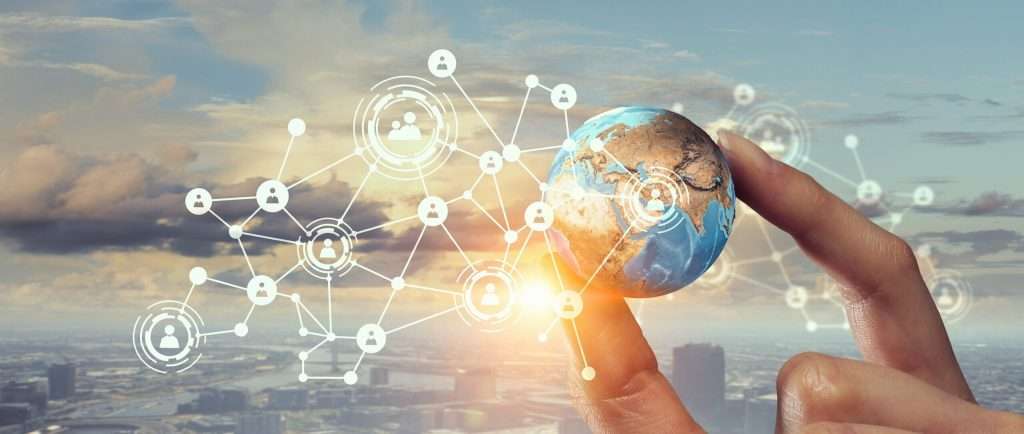 Hand holds networked digital globe above city