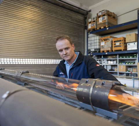 Technician checks machine part in workshop