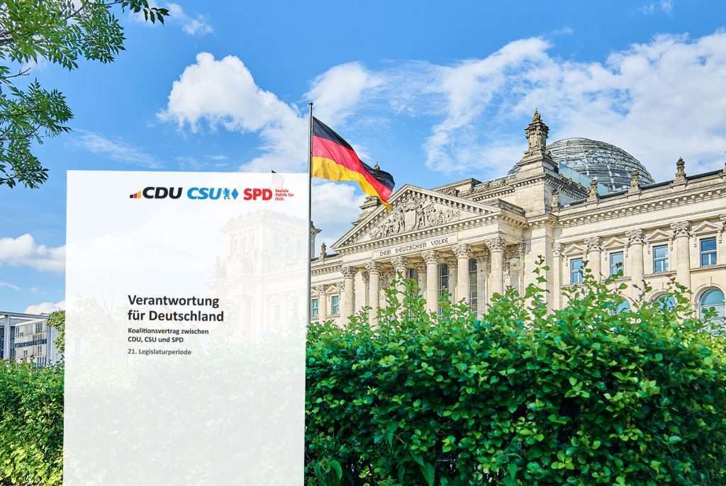 Reichstag building with German flag and CDU CSU SPD poster